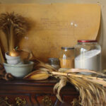 A still life by a Duluth MN artist showcases a wooden table holding a bundle of wheat, corn cobs, jars of flour and corn kernels, a stack of bowls with a gold-colored apple, and a blueprint in the background.