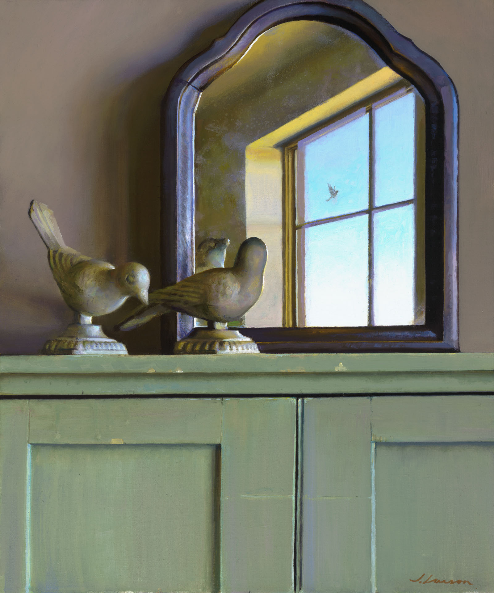 A wooden cabinet crafted by a Duluth MN artist showcases two bird sculptures in front of an arched mirror. The mirror reflects a window revealing a bright blue sky and a small bird in flight outside. The scene is calm and softly lit.