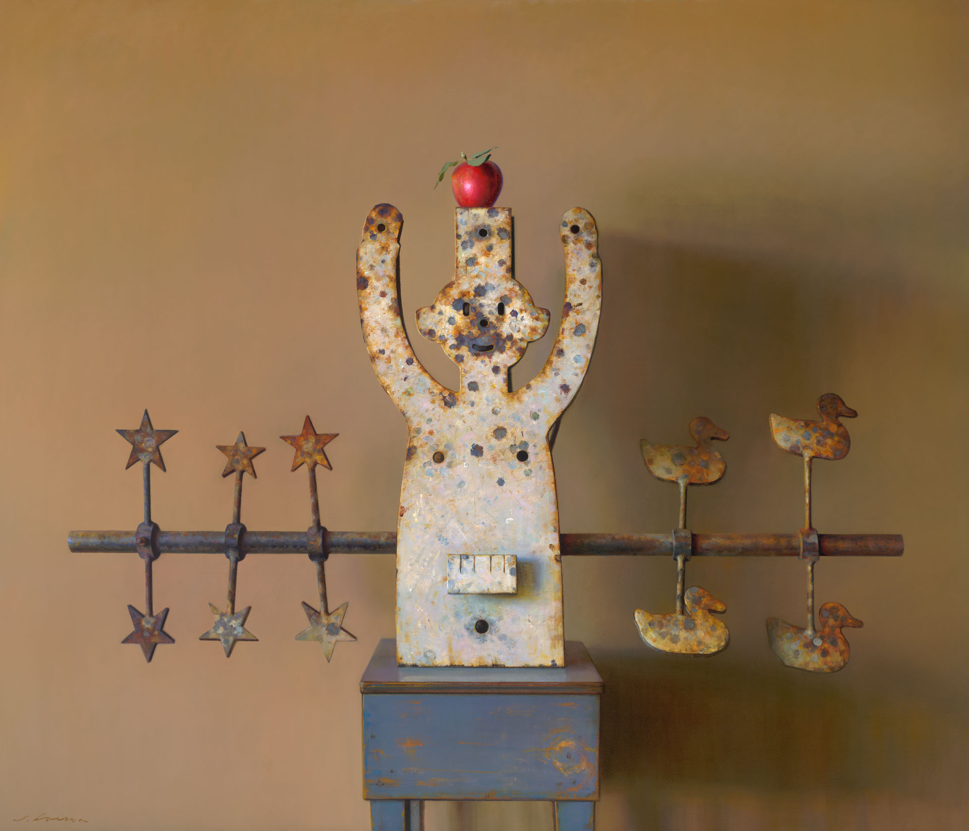 A creation by a Duluth MN artist, this sculpture stands with arms raised, topped with a red apple. A rod adorned with stars graces the left, while whimsical duck figures charm the right against a warm beige backdrop.
