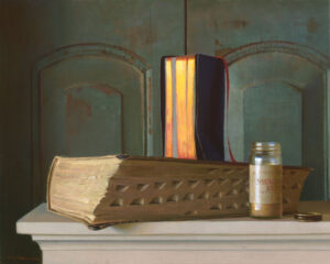 A thick, ornate book with a textured cover rests on a ledge beside a jar labeled "Mustard Seed." Crafted by a Duluth, MN artist, an open vertical book with glowing pages stands behind, casting a warm contrast against the dark, rustic background.