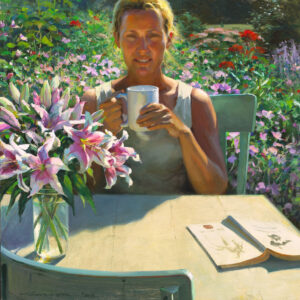 A Duluth MN artist enjoys a cup of coffee at a sunlit outdoor table, surrounded by vibrant flowers. A vase of lilies graces the table along with an open book displaying botanical illustrations, blending nature's beauty with artistic inspiration.