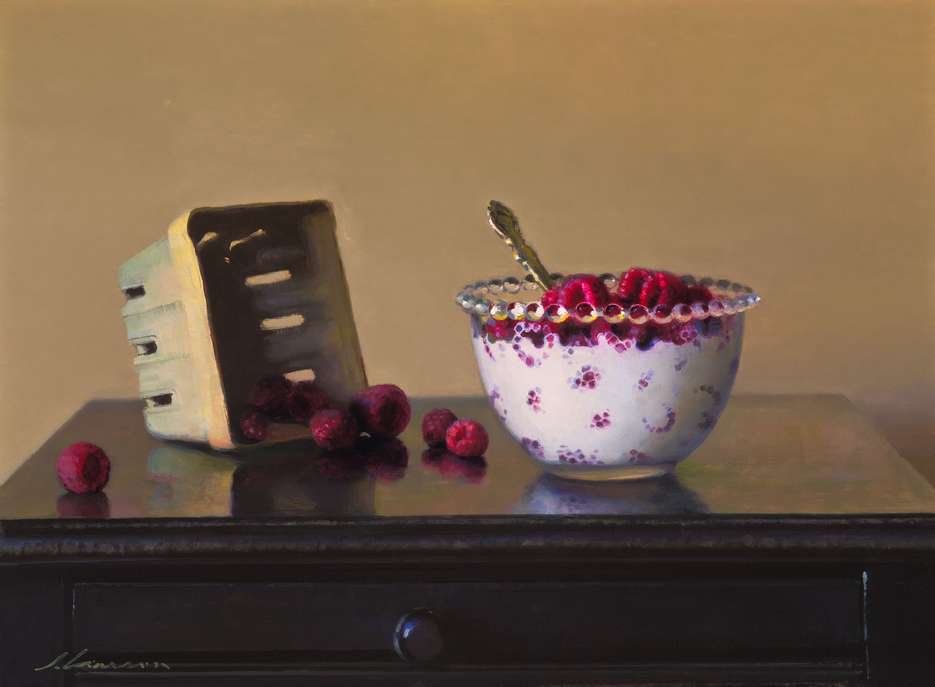 A still life painting by a Duluth MN artist features a wooden table adorned with a decorative bowl brimming with raspberries and a silver spoon. Nearby, an empty wooden basket rests, with scattered raspberries beside it against the backdrop of a plain beige wall.