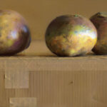 A painting by a Duluth MN artist features three round objects with metallic hues on a textured cardboard surface. The muted yellow background complements the reflective quality of the objects, while shadows and light enhance the scene's dimensionality.