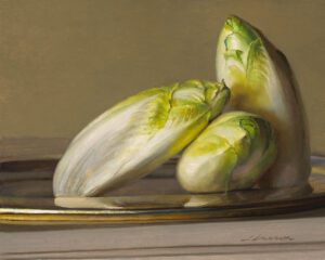 A still life by a Duluth MN artist features three heads of Belgian endive on a silver plate, set against a muted brown background. The green and white leaves exude a soft, natural sheen.