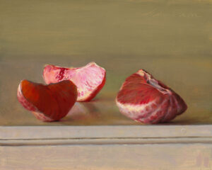 Three peeled citrus segments, crafted by a Duluth MN artist, rest on a neutral-toned surface against a muted background. Their vibrant hues contrast with the soft, even lighting, highlighting the fruit's texture and juiciness.