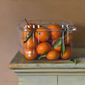 A clear plastic container filled with vivid orange tangerines, some still adorned with green leaves, sits on a wooden surface crafted by a talented Duluth MN artist. The setting exudes a warm and natural ambiance against the neutral background.