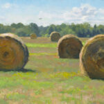 A scenic landscape painted by a talented Duluth MN artist captures a wide, grassy field dotted with large, round hay bales. The sky is bright blue with fluffy white clouds, and a line of trees graces the horizon.