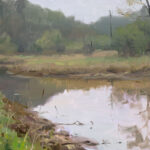 A serene landscape painting by a Duluth MN artist depicts a calm river reflecting the surrounding greenery and soft gray sky. The foreground features lush grass and reeds, while trees line the riverbank, creating a tranquil and natural scene.