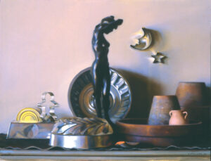 A collection of metallic kitchenware and decorative items by a Duluth MN artist is displayed on a shelf, featuring a black statue of a standing figure, moon and star cookie cutters, a gingerbread man mold, and various bowls and pots.