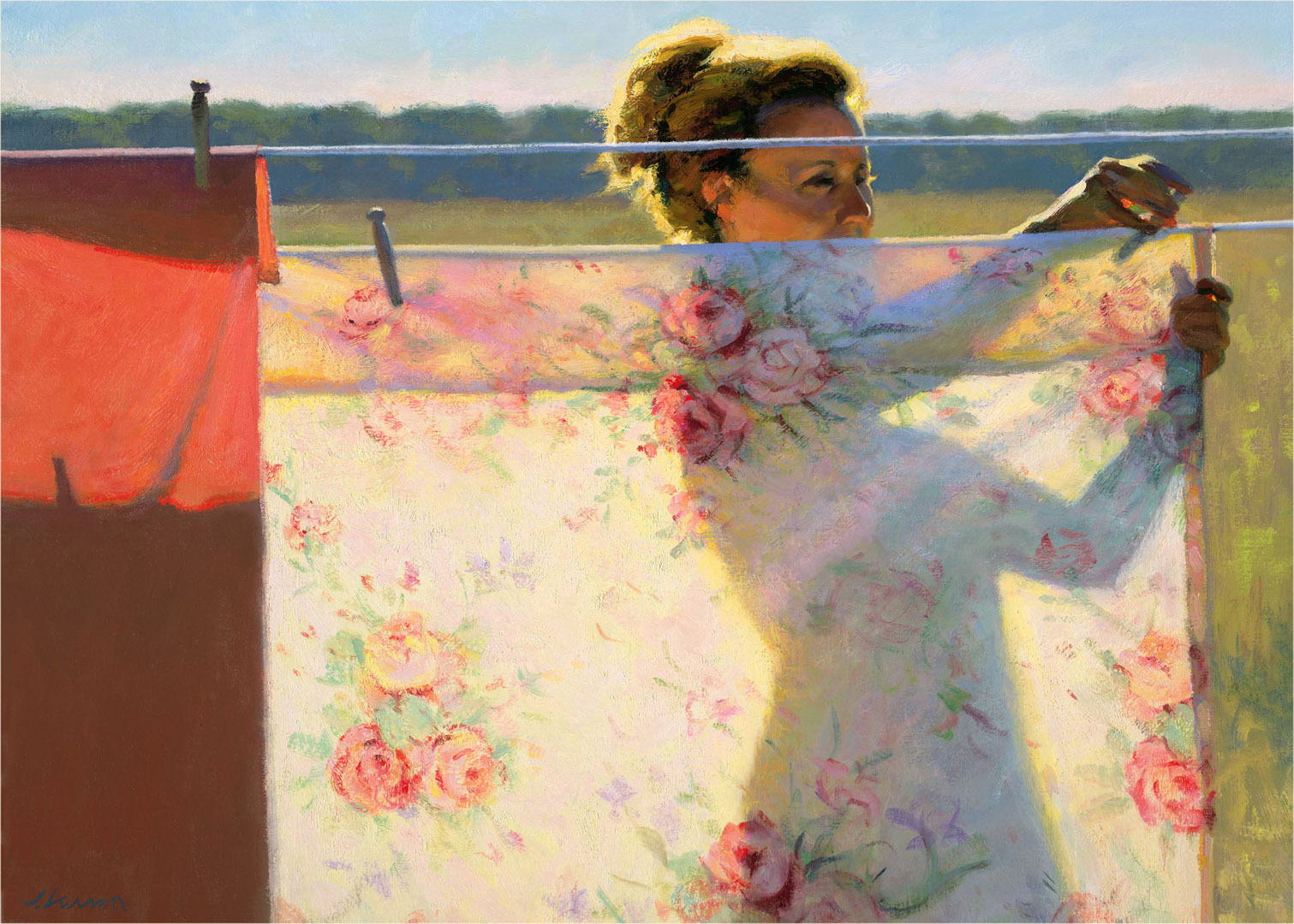 A Duluth MN artist hangs floral-patterned sheets on an outdoor clothesline. The scene is brightly lit by the sun, casting shadows on the fabric. In the background, a blurred landscape of fields unfurls under a clear sky.
