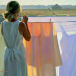 A woman in a white dress stands by a clothesline, facing away. She secures glowing laundry with a peg as warm sunlight bathes the scene. A rural landscape stretches under a soft sky, capturing the serene essence reminiscent of a Duluth MN artist's touch.