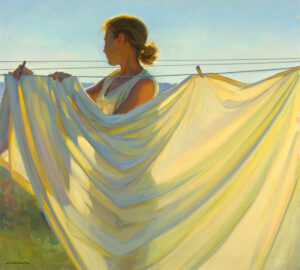 A Duluth MN artist hangs white sheets on a clothesline under a clear sky. The sunlight casts soft shadows on the fabric, highlighting the gentle folds and the serene setting. The figure's silhouette is illuminated by the warm, golden light, capturing a moment of simple artistry.