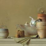 A still life by a Duluth MN artist showcases stacked clay pots, a small bird inside one, dandelion seeds, garlic bulbs in a ceramic dish, a ball of twine, and a folded cloth on a light-colored surface. An onion lies beside the dish, adding rustic charm to this serene composition.