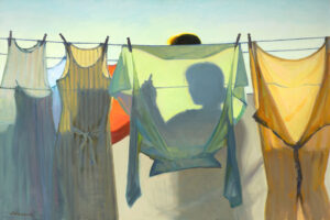 A series of colorful garments hang on a clothesline, casting shadows. The silhouette of a person, perhaps a Duluth MN artist, is visible behind one of the garments against a bright sky, giving the scene a warm and serene atmosphere.
