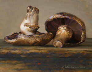 A still life painting by a Duluth MN artist depicts two mushrooms resting on a textured surface. One mushroom stands upright, while the other tilts to reveal its gills. The artwork features warm, earthy tones and a subtle play of light and shadow.