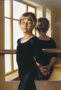 A young girl in a black ballet outfit, captured by a Duluth MN artist, stands in front of a mirror with her reflection visible. She gazes thoughtfully at the viewer, sunlight streaming through large windows in the background illuminating her contemplative expression.