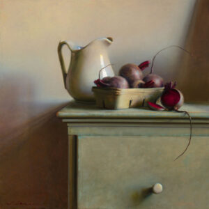 A still life by a Duluth MN artist features a cream-colored pitcher beside a basket of several whole beets and one sliced beet, resting on a teal wooden dresser. Soft lighting casts subtle shadows, creating a calm ambiance.