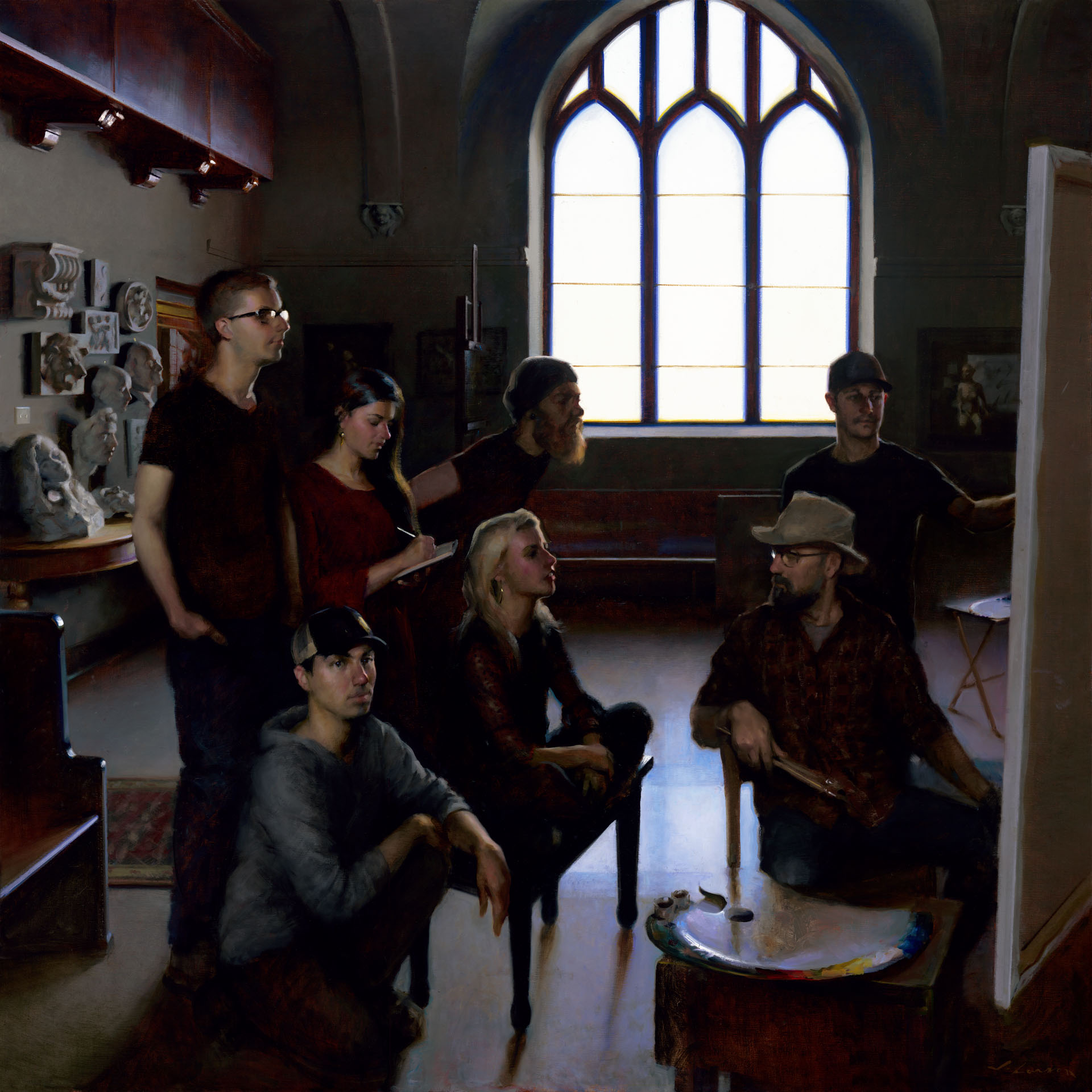A group of seven people, some seated and some standing, are gathered in an art atelier. They are focused on a canvas while sunlight streams through a large arched window, reminiscent of a Minnesota morning. Art supplies and sculptures are scattered throughout the room.