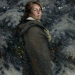 A Duluth MN artist wearing a dark green cloak stands in a snowy forest, looking back over their shoulder. Snowflakes fall around them, blending softly into the evergreen trees in the background.