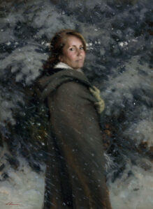 A Duluth MN artist wearing a dark green cloak stands in a snowy forest, looking back over their shoulder. Snowflakes fall around them, blending softly into the evergreen trees in the background.
